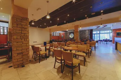 a restaurant with tables and chairs in a room at Hotel Montenegro in Budva
