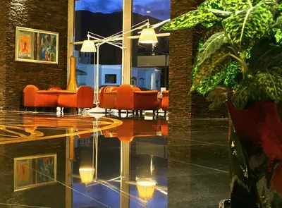 a dining room with orange chairs and a glass table at Splendid Conference & Spa Resort in Budva