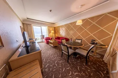 a hotel room with a table and a living room at Splendid Conference & Spa Resort in Budva