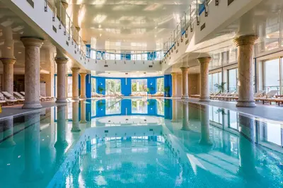 a swimming pool in a building with columns at Splendid Conference & Spa Resort in Budva