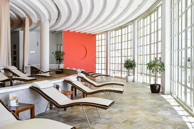 a row of chairs in a room with large windows at Splendid Conference & Spa Resort in Budva