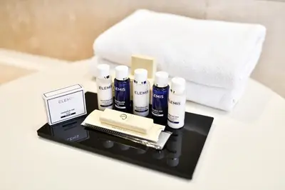 a tray with several products on a bed at Splendid Conference & Spa Resort in Budva