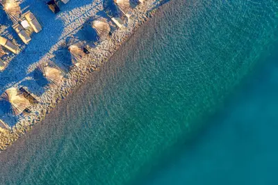 an aerial view of a beach with umbrellas and the ocean at Aquata Apartments in Tivat