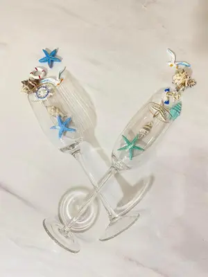 a clear glass wine glass with figurines on it at Aquata Apartments in Tivat