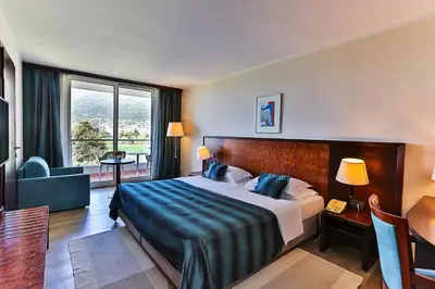 a hotel room with a large bed and a window at Hotel Princess in Bar