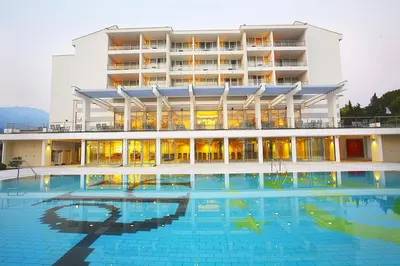 a large building with a swimming pool in front of it at Hotel Princess in Bar