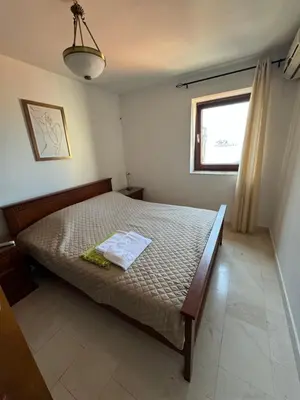 a bedroom with a bed and a window at Seaview Apartments VERA in Petrovac na Moru