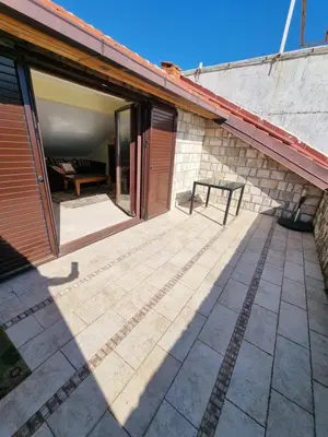 a patio with a bench on the side of a building at Seaview Apartments VERA in Petrovac na Moru