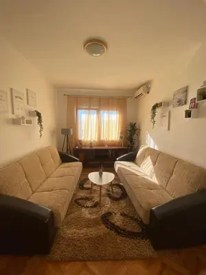 a living room with a couch and a table at Green House Pejovic in Podgorica