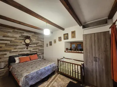 a bedroom with a bed and a clock on the wall at Apartments 