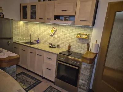 a kitchen with a sink and a stove top oven at Apartments 