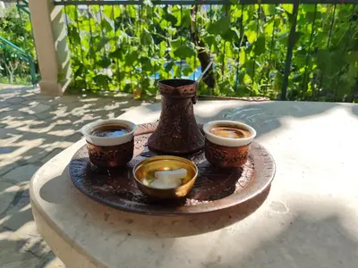 a tray with three cups and a vase on a table at Apartments 