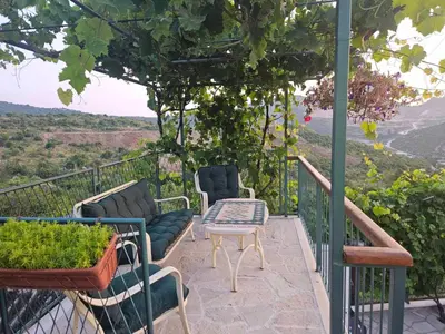 a balcony with chairs and a table and a view at Apartments 