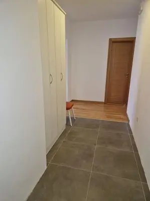 a room with a hallway with a door and a tiled floor at Your second home in Podgorica in Podgorica