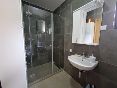 a bathroom with a sink and a shower at Your second home in Podgorica in Podgorica