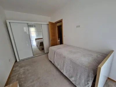 a bedroom with a bed and a large mirror at Your second home in Podgorica in Podgorica