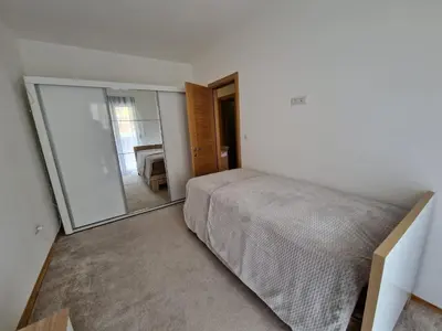 a bedroom with a bed and a large mirror at Your second home in Podgorica in Podgorica