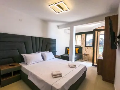 a bedroom with a large bed with two towels on it at Sand Apartments in Ulcinj
