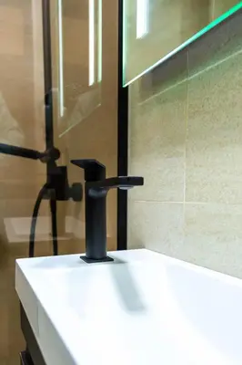 a bathroom sink with a black faucet on it at Sand Apartments in Ulcinj