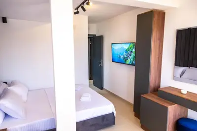 a bedroom with a bed and a tv on the wall at Sand Apartments in Ulcinj