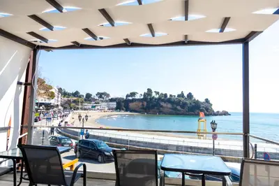 a balcony with chairs and a view of a beach at Sand Apartments in Ulcinj