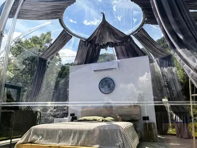 a bedroom with a bed in a glass tent at ZEN Relaxing Village in Cetinje