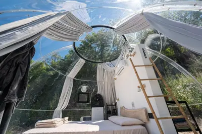 a room with a mirror and a ladder and a bed at ZEN Relaxing Village in Cetinje