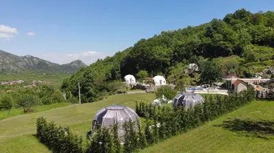 a group of domes in a field with trees at ZEN Relaxing Village in Cetinje