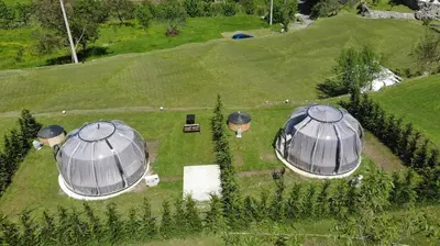 an overhead view of two domes in a field with trees at ZEN Relaxing Village in Cetinje