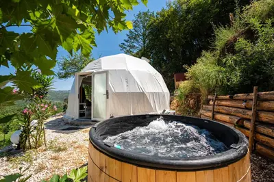 a hot tub in front of a tent at ZEN Relaxing Village in Cetinje