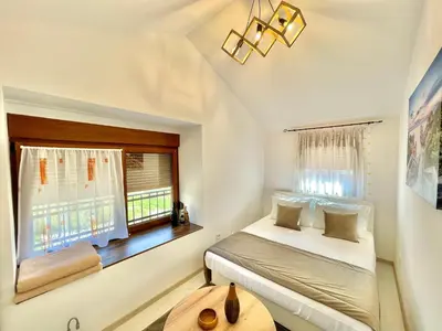 a bedroom with a bed and a window at Villa Serenity Budva in Budva