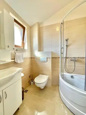a bathroom with a toilet and a sink and a tub at Villa Serenity Budva in Budva