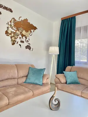 a living room with a couch and a world map on the wall at Villa Serenity Budva in Budva