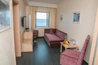 a living room with a couch and a table at Hotel Astoria in Budva