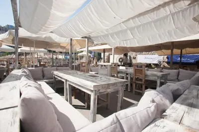 a table and chairs under a large white umbrella at Hotel Astoria in Budva
