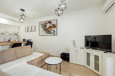 a living room with a couch and a table at APARTLU in Kotor