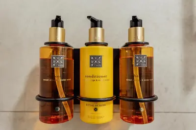 a group of four bottles of liquids sitting on a counter at APARTLU in Kotor
