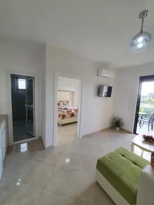a living room with a couch and a bedroom at Apartments Alsa in Ulcinj