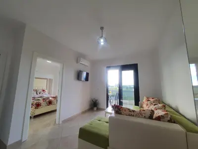 a living room with a couch and a bedroom at Apartments Alsa in Ulcinj