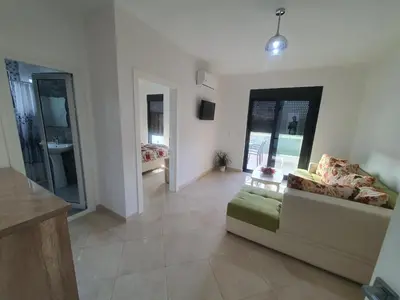 a large living room with a couch and a table at Apartments Alsa in Ulcinj