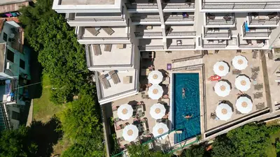 an overhead view of a building with a pool with umbrellas at Hotel Pima Budva in Budva