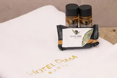 a box of cuddle cure care products on a towel at Hotel Pima Budva in Budva