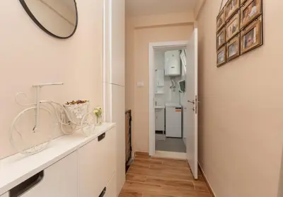 a bathroom with a sink and a mirror at Apartman Oasis in Kotor