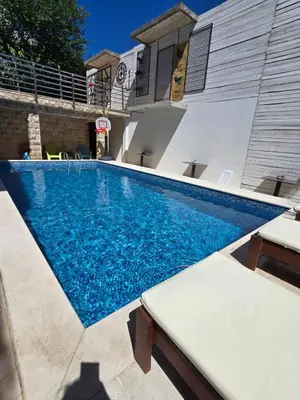 a swimming pool in the backyard of a house at Apartments TP 777 in Budva