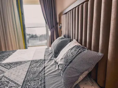 a bed with two pillows on it with a window at Apartment Ra Przno Budva in Budva