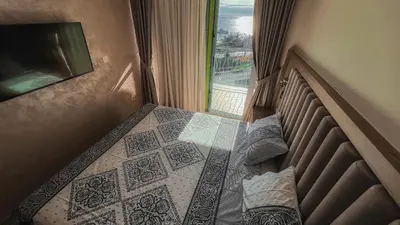 a bedroom with a bed with a view of a window at Apartment Ra Przno Budva in Budva