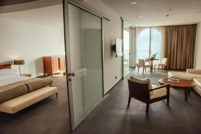 a hotel room with a bed and a living room at Avala Resort & Villas in Budva