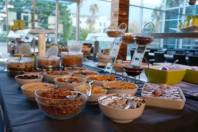 a table with many bowls of food on it at Avala Resort & Villas in Budva