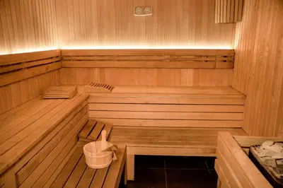 a sauna with two benches and a bucket in it at Avala Resort & Villas in Budva