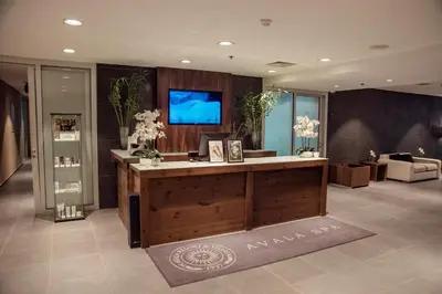 a lobby with a reception desk with a tv on the wall at Avala Resort & Villas in Budva